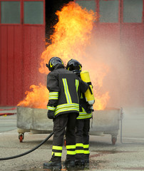 firefighters with oxygen bottles off the fire during a training