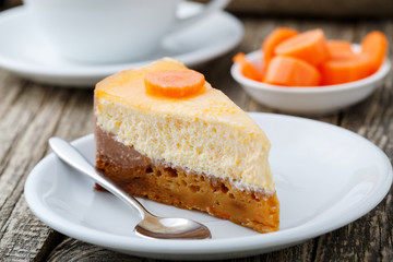Sweet slice of carrot cake with coffee cup.