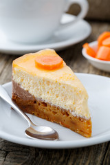 Sweet slice of carrot cake with coffee cup.