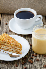 Tasty honey cake with jar of honey.