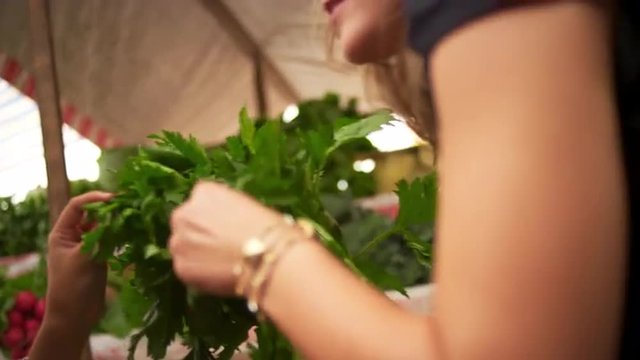 Mother and daughter pick fresh produce at a street market