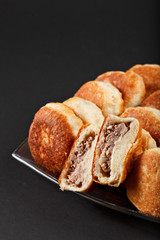 hot tasty traditional russian baking small pie with meat from ow