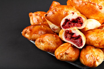 hot tasty traditional russian baking small pie with berries and