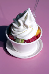 White glass with fresh fruit and ice-cream close-up