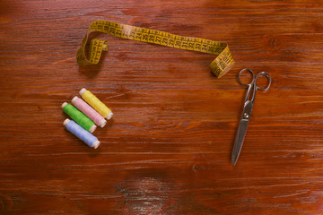 Colored threads, scissors, and tape measure