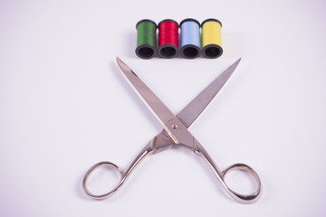 Thread green, red, blue, and yellow with scissors.