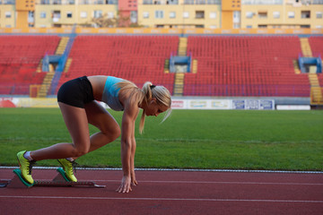 woman  sprinter leaving starting blocks