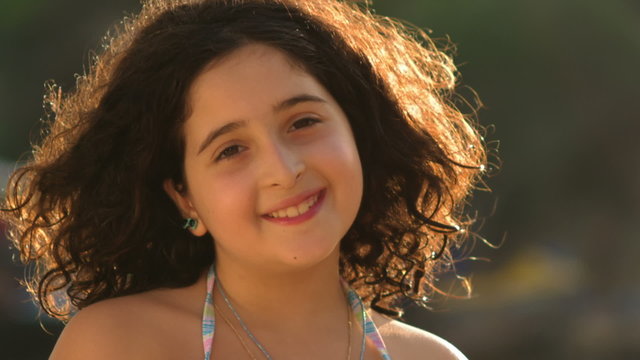 A Portrait Of A Young Girl At The Beach During Magic Hour