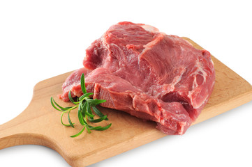 Fresh raw meat and rosemary on a wooden board