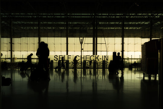 silhouette of travelers at the airport