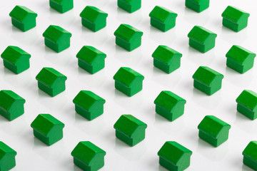 Grid of green houses making a community in the property market.