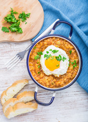 Fried egg with cooked lentils