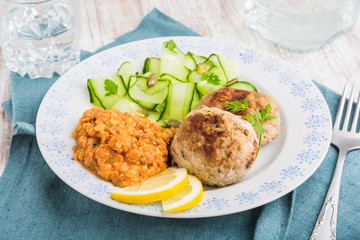 Delicious fried beef meatball, lentils and salad with fresh cucumber