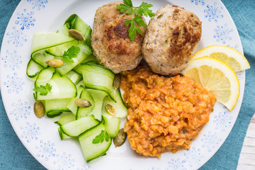 Delicious fried beef meatball, lentils and salad with fresh cucumber