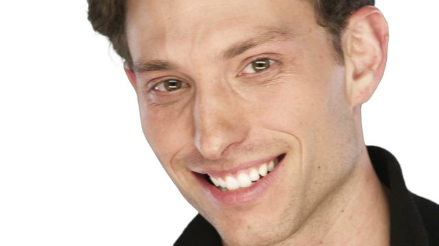 Man smiles into the camera on a white background