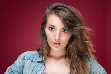 Portrait of a beautiful young woman on red background