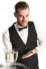 Waiter in his 20s serving champagne wearing a shirt and vest