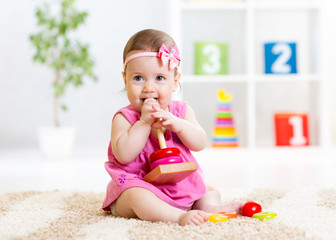 Child girl playing with toy at home