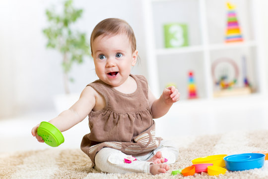 baby girl playing with colorful toys