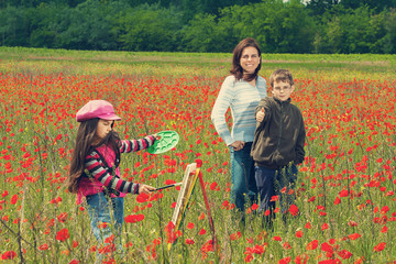 Vintage family on the poppy meadow