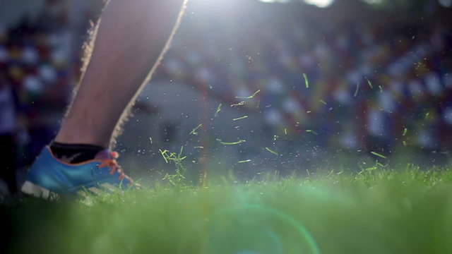 Soccer player doing kick with ball on football stadium - slow