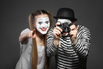 Funny couple of mimes taking a photo