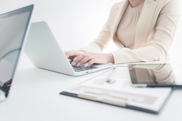 Unrecognizable business person analyzing graphs and taking notes
