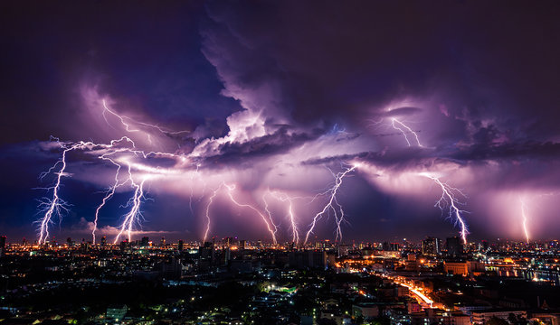 Lightning storm over city in purple light © stnazkul