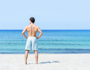 Fototapeta na wymiar Young and handsome man on a summer beach