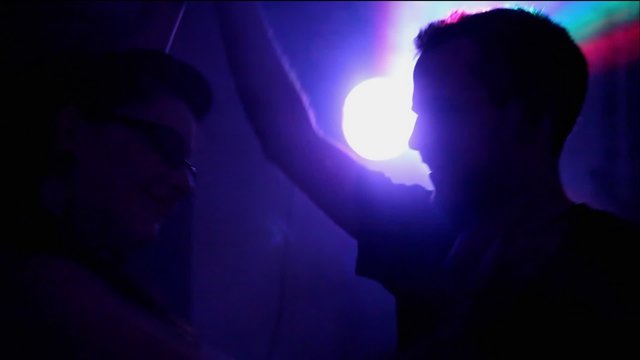 A Couple Dance in Extreme Lighting at a party