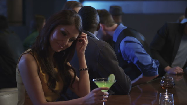 A guy at a bar meets a young woman then flirts with her