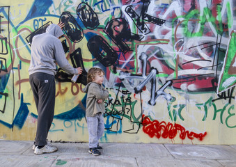young toddler unhappy with graffiti hoody