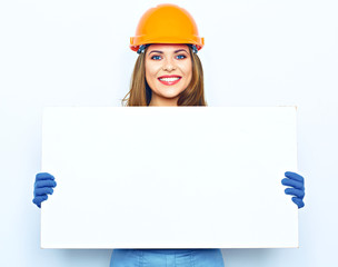 Smiling woman builder coverall dressed holding big board for ad