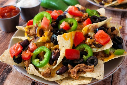 Mexican nachos with ground meat, jalapenos, tomatoes, and cheese