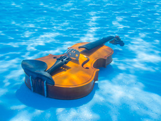 Violin underwater in the pool