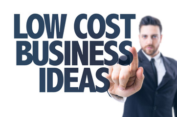 Business man pointing the text: Low Cost Business Ideas
