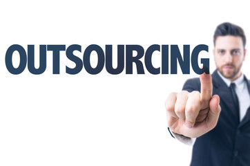 Business man pointing the text: Outsourcing