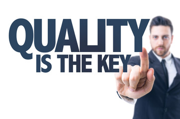 Business man pointing the text: Quality is the Key