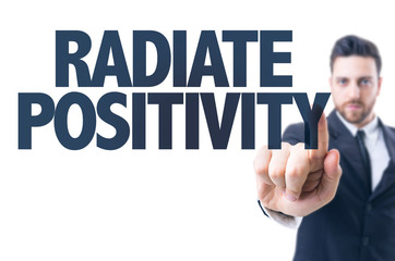 Business man pointing the text: Radiate Positivity