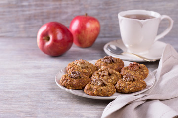 Oatmeal cookies with walnuts, apples and a cup of tea 