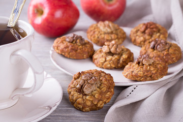 Oatmeal cookies with walnuts, apples and a cup of tea 