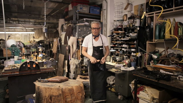 A designer works at his desk in his workshop