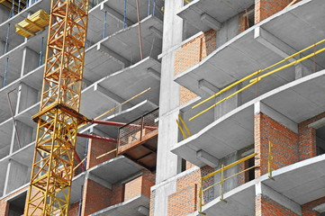 Crane and building construction site with balcony