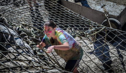 Colorado Mud Run climbing rope netting on side of big mountain