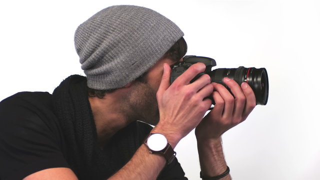 A young photographer takes pictures in a studio 
