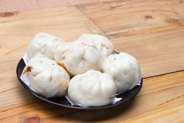 Chinese steamed buns  on wood background.