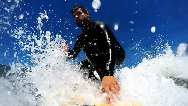 Young man enjoying the surfing in Waves. Slow motion.