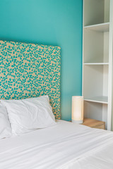 Bedside cabinet. / Wooden bedside table and reading lamp.