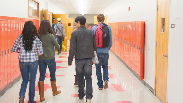 A busy school hallway with students walking to and from class