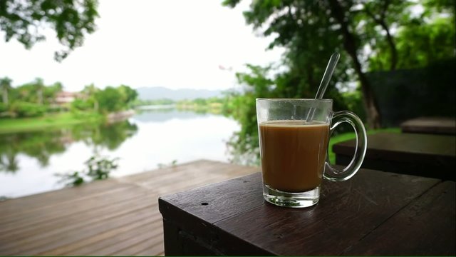 hot coffee in clear glass with nature background